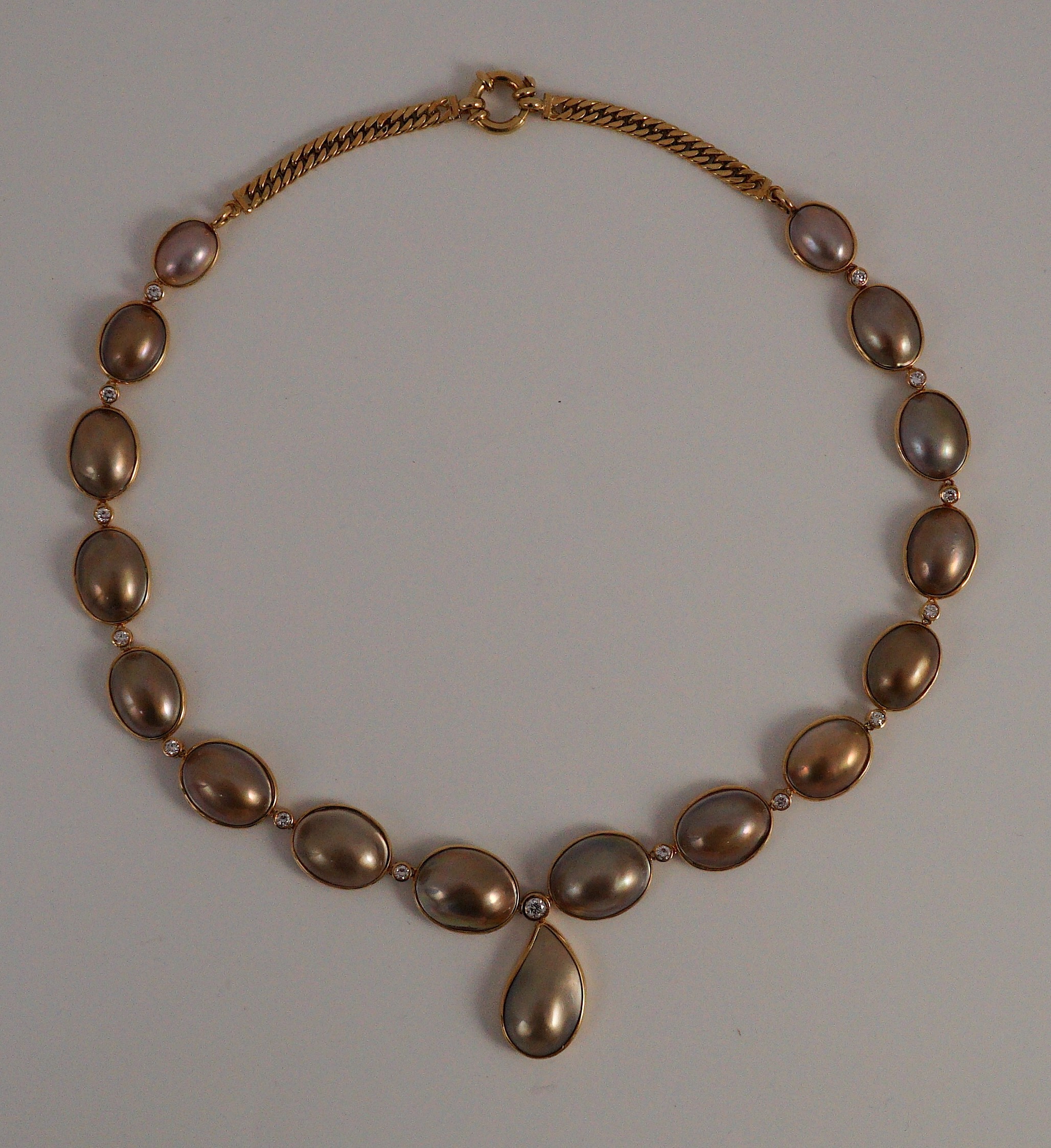 A cased modern single strand graduated shaped mabe pearl and round brilliant cut diamond set drop necklace, with 18ct gold clasp and chain section